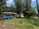 Exterior of a home under construction, featuring an overgrown lawn and concrete block additions at 625 E Jackson Ave, Mount Dora, FL 32757