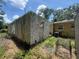 Home addition featuring concrete blocks and an overgrown yard at 625 E Jackson Ave, Mount Dora, FL 32757