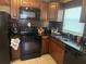 Updated kitchen features black appliances, tile backsplash, and granite counters at 625 E Jackson Ave, Mount Dora, FL 32757