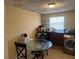 Bright laundry room boasts a glass table, updated washer and dryer, and a full size window at 625 E Jackson Ave, Mount Dora, FL 32757