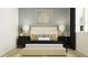 This bedroom has a neutral color palette with black nightstands and lamps at 640 Terrapin Dr, Debary, FL 32713