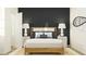 This bedroom has a black accent wall and symmetrical white bedside tables at 640 Terrapin Dr, Debary, FL 32713