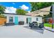 Backyard patio with seating area, barbecue grill, with view of the home's exterior at 7616 Simms Ave, Orlando, FL 32812