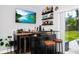 Bar area featuring wet bar, beverage cooler, mounted television, and convenient backyard access at 7616 Simms Ave, Orlando, FL 32812