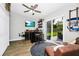 Bar room featuring a wet bar, stools, access to the backyard, and a mounted television at 7616 Simms Ave, Orlando, FL 32812