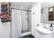 Modern bathroom featuring tiled shower, vanity with sink, and a rustic towel rack with rolled towels at 7616 Simms Ave, Orlando, FL 32812