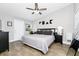 Bright bedroom with a neutral color scheme, ceiling fan, and wood-look tile flooring at 7616 Simms Ave, Orlando, FL 32812