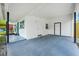 Spacious white carport featuring two doors, painted floor and ample natural light at 7616 Simms Ave, Orlando, FL 32812