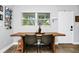 Charming dining area features a rustic wooden table, seating and an exterior door at 7616 Simms Ave, Orlando, FL 32812