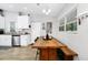 Bright dining area features a wooden table, bench seating, and stylish decor at 7616 Simms Ave, Orlando, FL 32812