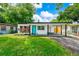 Charming single-story home featuring a modern design, a well-manicured lawn and carport at 7616 Simms Ave, Orlando, FL 32812