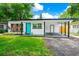 Charming single-story home featuring a modern design, a well-manicured lawn and carport at 7616 Simms Ave, Orlando, FL 32812