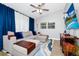 Comfortable living room with an elegant sectional sofa, ceiling fan and entertainment center with a mounted television at 7616 Simms Ave, Orlando, FL 32812