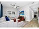 Comfortable living room with an elegant sectional sofa, ceiling fan and entertainment center with a mounted television at 7616 Simms Ave, Orlando, FL 32812