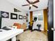 Home office featuring a desk, exercise equipment, and display of framed diplomas at 7616 Simms Ave, Orlando, FL 32812