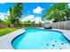 Close up of backyard pool with tile steps and surrounding lush lawn at 7616 Simms Ave, Orlando, FL 32812