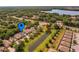 Aerial view of house in residential neighborhood close to large pond and commercial area at 879 Nonastone Run, Casselberry, FL 32707