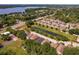 Scenic aerial view of a residential area with homes and a large lake in the distance at 879 Nonastone Run, Casselberry, FL 32707