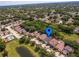 Beautiful aerial view of home in lush green neighborhood with nearby pool and water features at 879 Nonastone Run, Casselberry, FL 32707