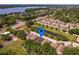 Scenic aerial view of a residential area with homes and a large lake in the distance at 879 Nonastone Run, Casselberry, FL 32707