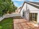 Home exterior view of backyard featuring concrete patio, white fence and green lawn at 879 Nonastone Run, Casselberry, FL 32707