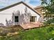 Home exterior with sliding glass doors to concrete patio and green backyard at 879 Nonastone Run, Casselberry, FL 32707