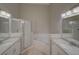 Bright bathroom featuring double sinks, a shower, and jacuzzi tub at 879 Nonastone Run, Casselberry, FL 32707