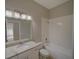 This bathroom features a white vanity, granite countertop, and a shower and tub combo at 879 Nonastone Run, Casselberry, FL 32707