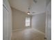 This is an empty bedroom with a ceiling fan, tile floors, and a view to the exterior at 879 Nonastone Run, Casselberry, FL 32707