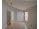 Neutral toned bedroom with a window and a double door closet at 879 Nonastone Run, Casselberry, FL 32707