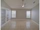 Neutral toned bedroom featuring tile floors, a ceiling fan, and French doors at 879 Nonastone Run, Casselberry, FL 32707