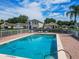 Inviting community pool surrounded by a fence with lounge chairs and serene neighborhood views at 879 Nonastone Run, Casselberry, FL 32707