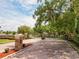 Gated community entrance with brick-paved road and lush landscaping on a beautiful sunny day at 879 Nonastone Run, Casselberry, FL 32707