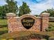 Elegant stone community sign with 'Royal Oaks' in gold lettering, surrounded by lush landscaping at 879 Nonastone Run, Casselberry, FL 32707