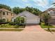 Charming single-story home with a well-maintained lawn, mature palm trees, and an attached two-car garage at 879 Nonastone Run, Casselberry, FL 32707