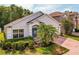Charming single-story home with a well-maintained lawn, mature palm trees, and a blue front door at 879 Nonastone Run, Casselberry, FL 32707