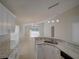 Open-concept kitchen with stainless steel appliances, white cabinets, and granite countertops at 879 Nonastone Run, Casselberry, FL 32707
