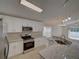 Spacious kitchen features stainless steel appliances, white cabinets, and granite countertops at 879 Nonastone Run, Casselberry, FL 32707