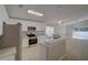 Open-concept kitchen boasts stainless steel appliances, white cabinets, and granite countertops at 879 Nonastone Run, Casselberry, FL 32707