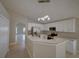 Bright kitchen with stainless steel appliances, white cabinets, and speckled granite countertops at 879 Nonastone Run, Casselberry, FL 32707