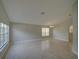 Spacious, neutral-toned living room with tile flooring and abundant natural light at 879 Nonastone Run, Casselberry, FL 32707