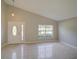 Bright living room with tile floors, vaulted ceilings, and natural light at 879 Nonastone Run, Casselberry, FL 32707