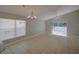 Bright living room with tile flooring, modern chandelier, and sliding glass doors to the patio at 879 Nonastone Run, Casselberry, FL 32707
