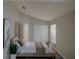 This is a staged main bedroom featuring a large bed, white closet doors, and a modern decor at 879 Nonastone Run, Casselberry, FL 32707