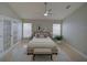 Staged bedroom featuring tile floors, ceiling fan, French doors, and natural light at 879 Nonastone Run, Casselberry, FL 32707