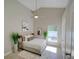 This is a staged main bedroom featuring modern decor, large window, and white tile floors at 879 Nonastone Run, Casselberry, FL 32707