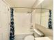 Bathroom featuring a tub and shower with a white tiled surround and a blue patterned shower curtain at 936 Birmingham Ct # 200, Lake Mary, FL 32746