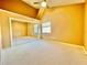 Bedroom featuring vaulted ceilings, neutral carpet and paint, with sliding glass doors to closet at 936 Birmingham Ct # 200, Lake Mary, FL 32746