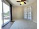 Bright bedroom with carpet, ceiling fan, balcony access, and large closet at 936 Birmingham Ct # 200, Lake Mary, FL 32746