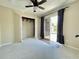 Bedroom featuring neutral carpet and paint, a sliding glass door to the exterior, and closet storage at 936 Birmingham Ct # 200, Lake Mary, FL 32746